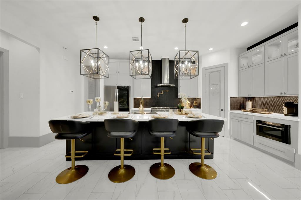 a view of kitchen island with stainless steel appliances kitchen island dining table and chairs