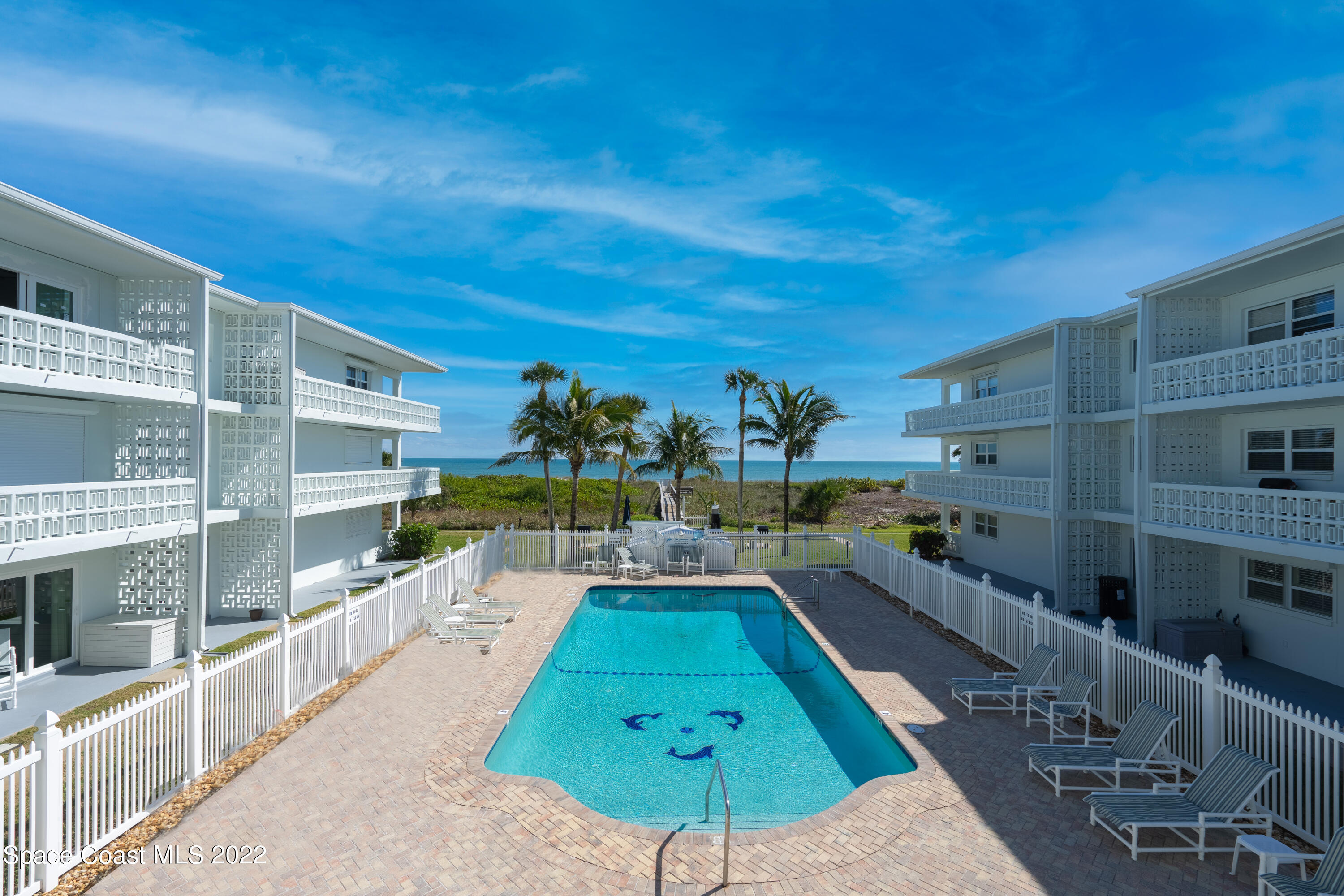 a swimming pool with outdoor seating and yard