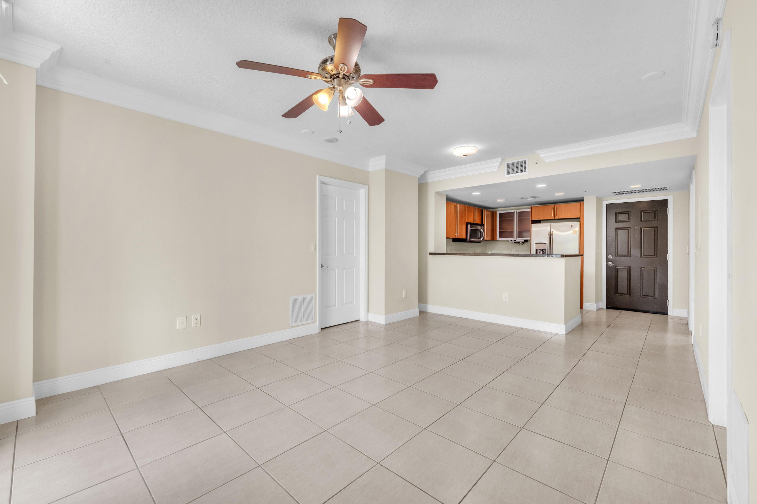 a view of a livingroom with wooden floor and a ceiling fan