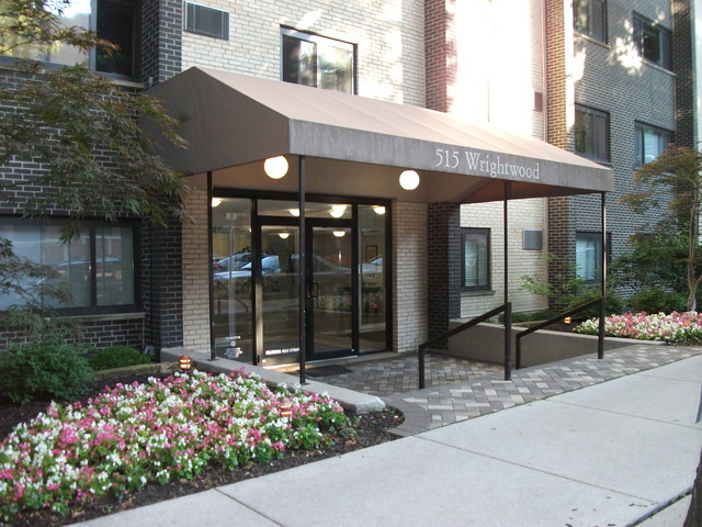 a front view of a building with a garden