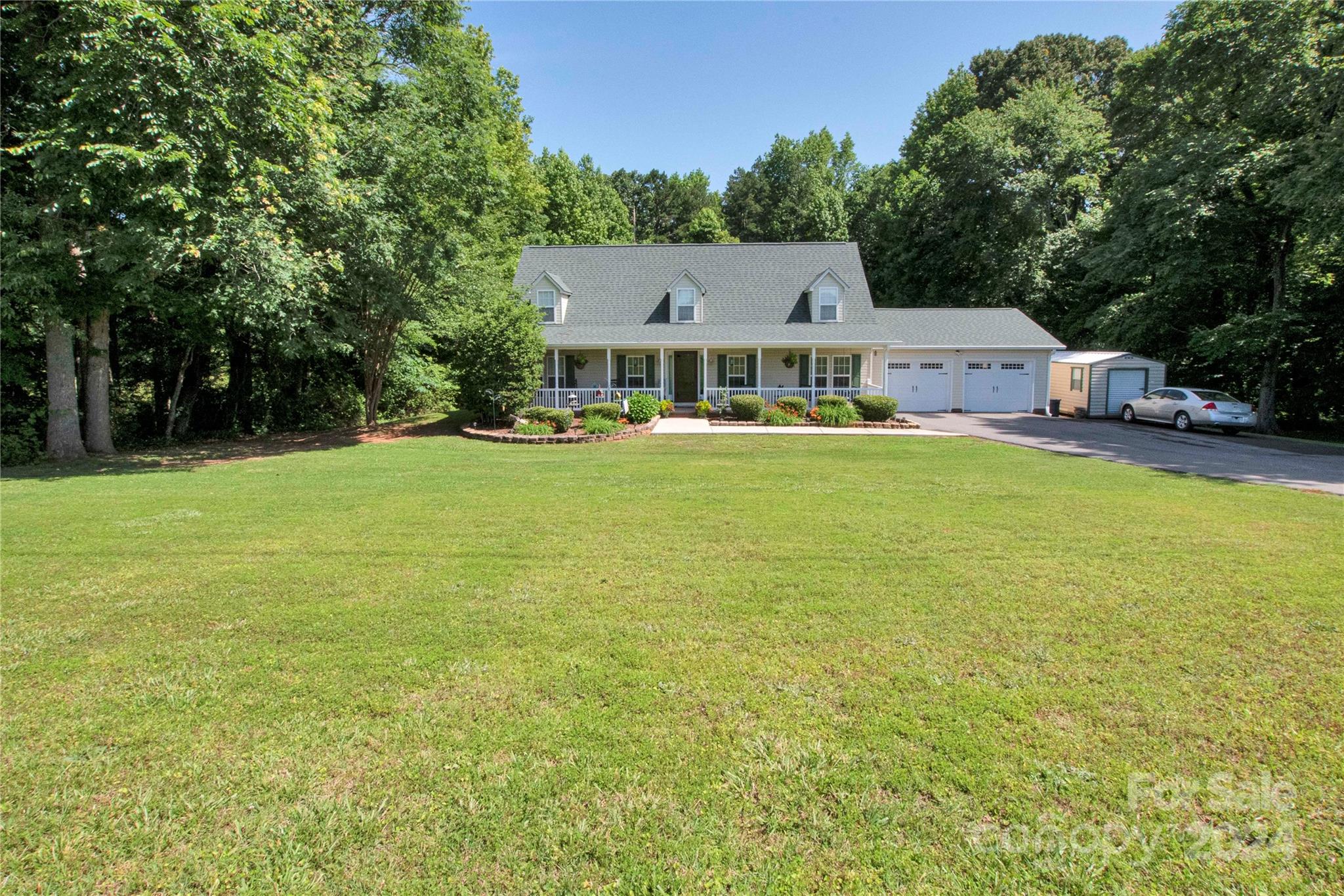 a front view of a house with yard and green space