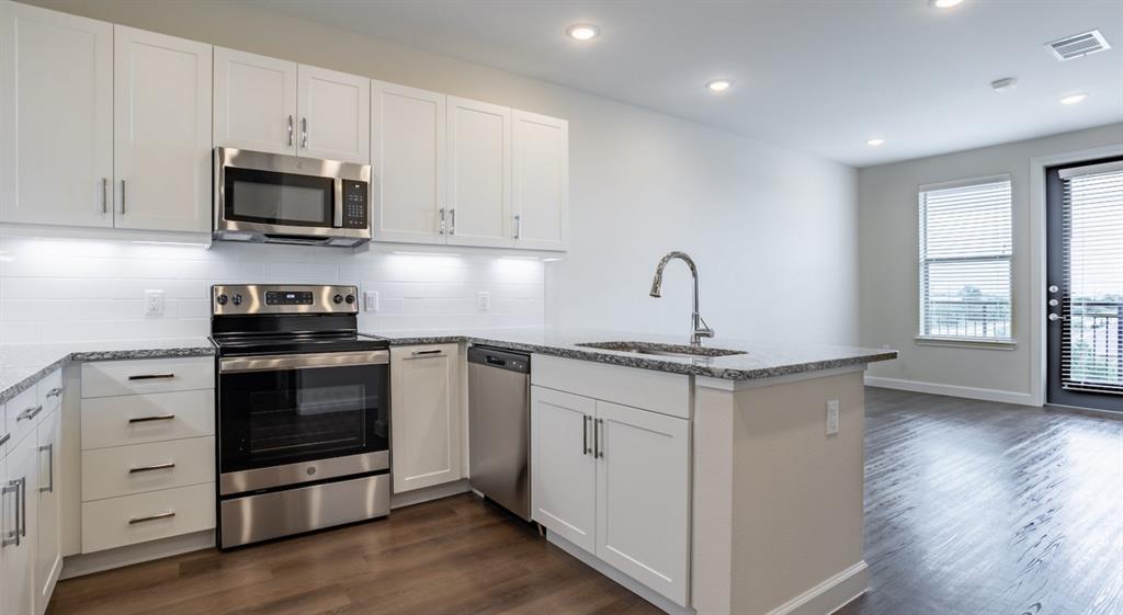 a kitchen with granite countertop a stove and a sink