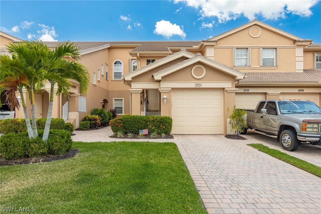 a front view of a house with a yard and garage