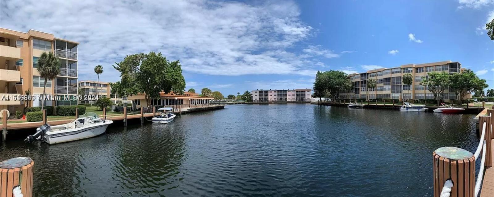 a view of residential house with outdoor space and lake view