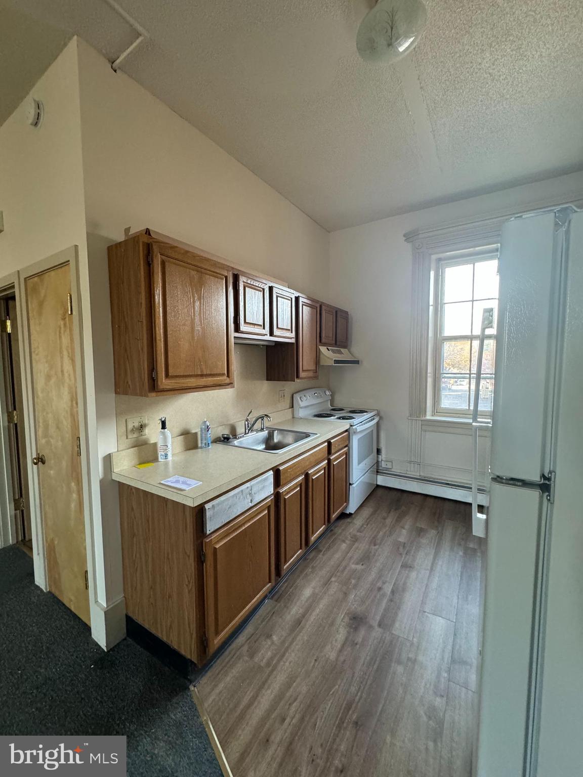 a kitchen with stainless steel appliances granite countertop a stove a sink dishwasher and a refrigerator