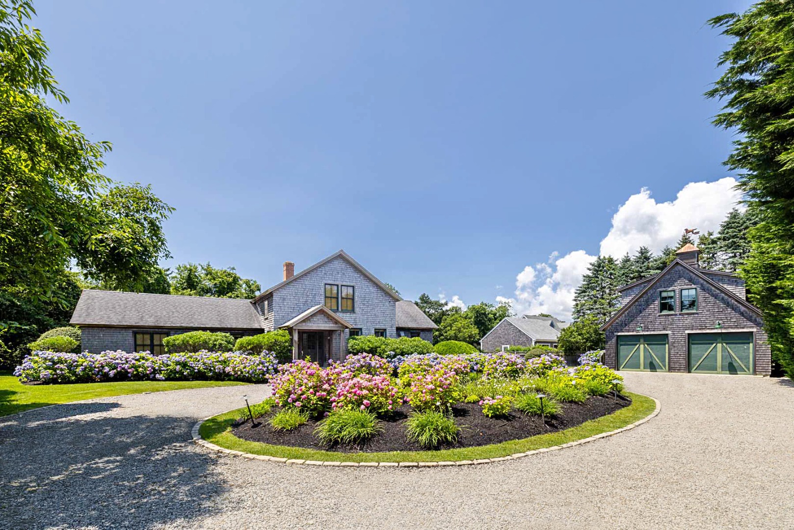 a front view of a house with a garden