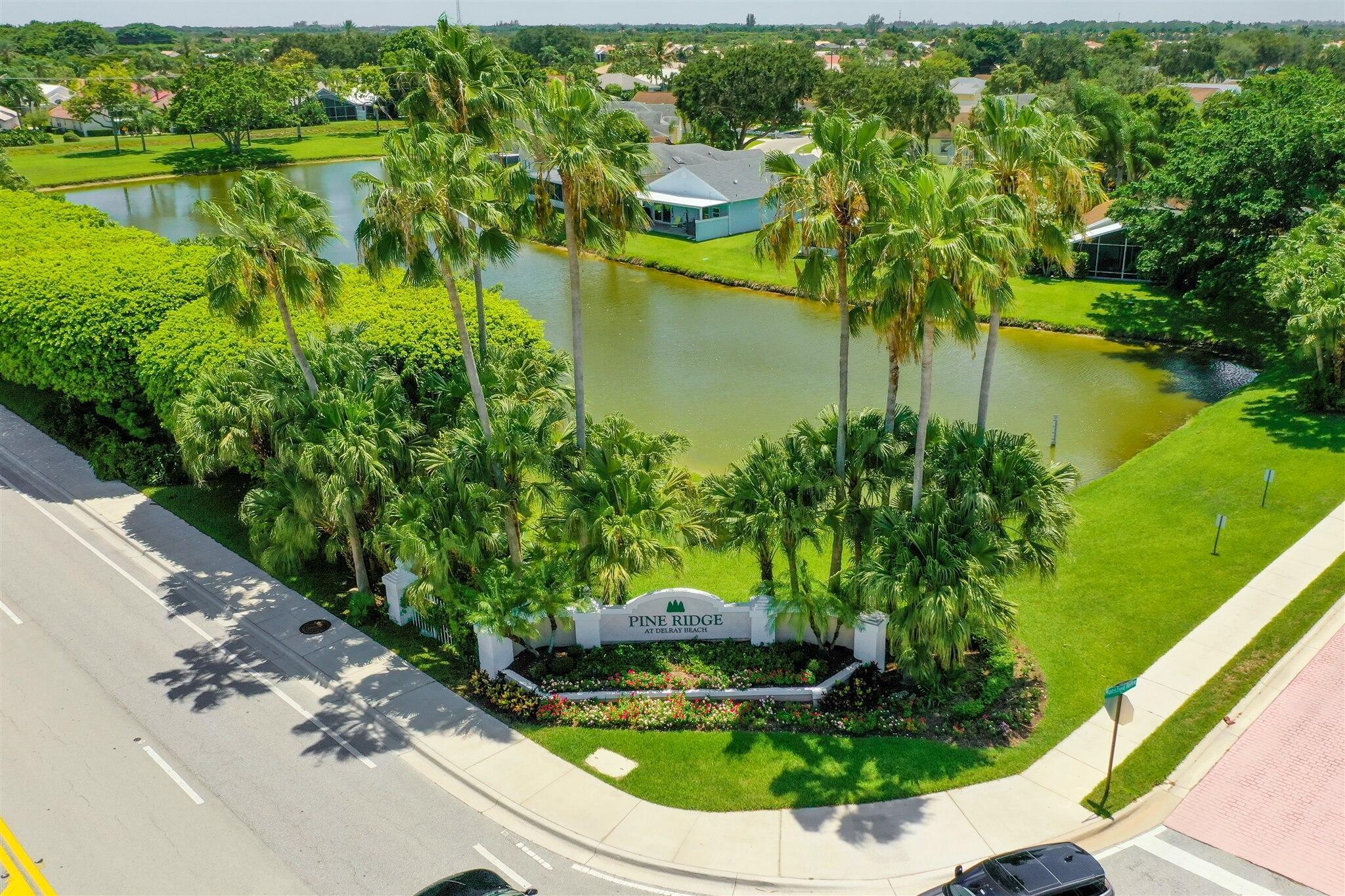 an aerial view of water body with boats and trees all around