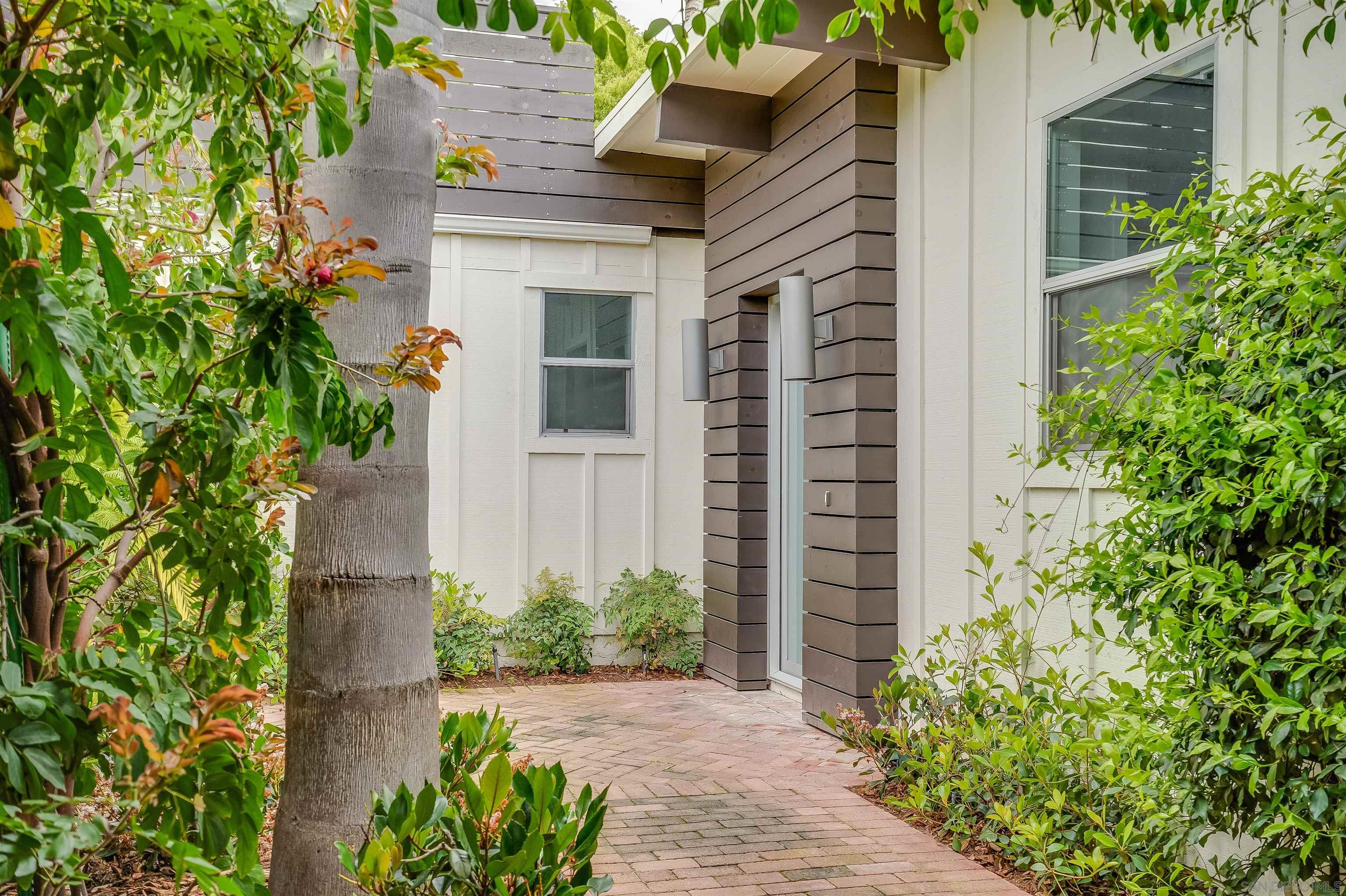 front view of a house with potted plants