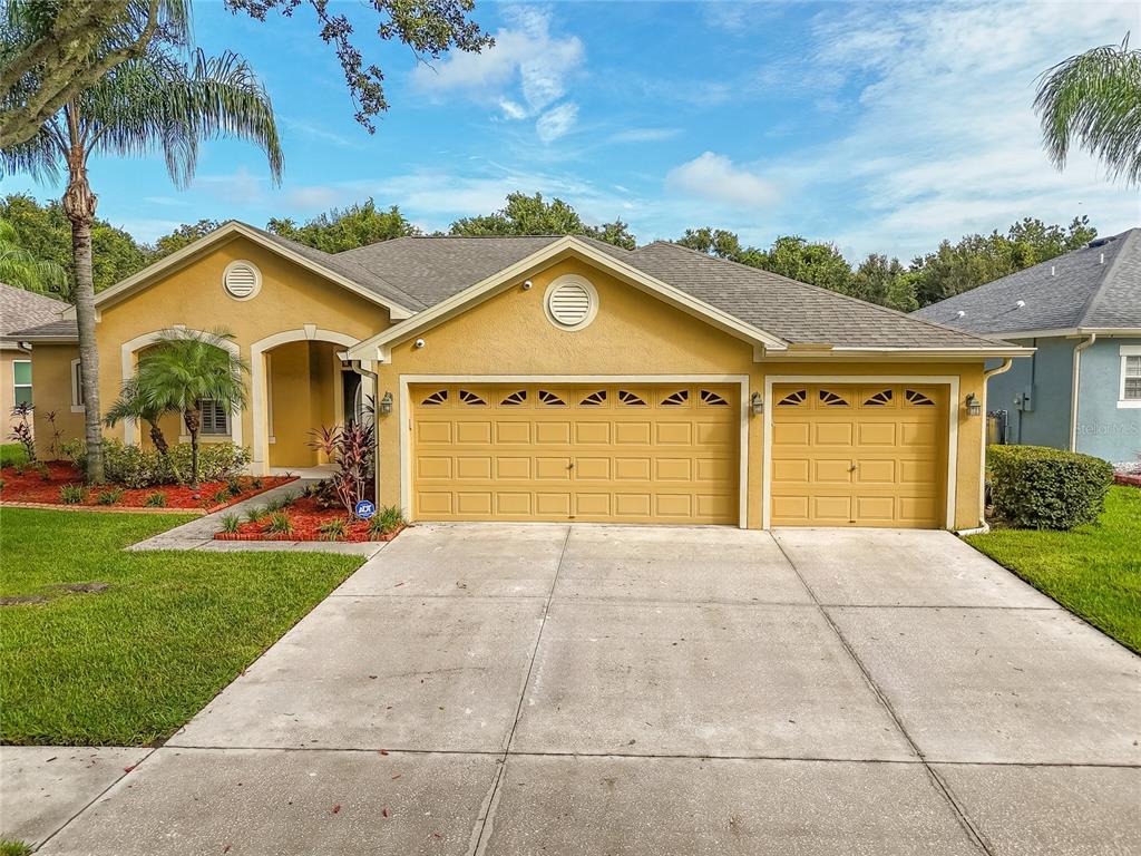 a front view of a house with a yard and garage