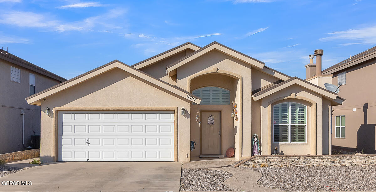 a front view of a house with a garage