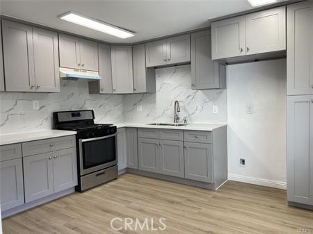 a kitchen with a sink cabinets and appliances