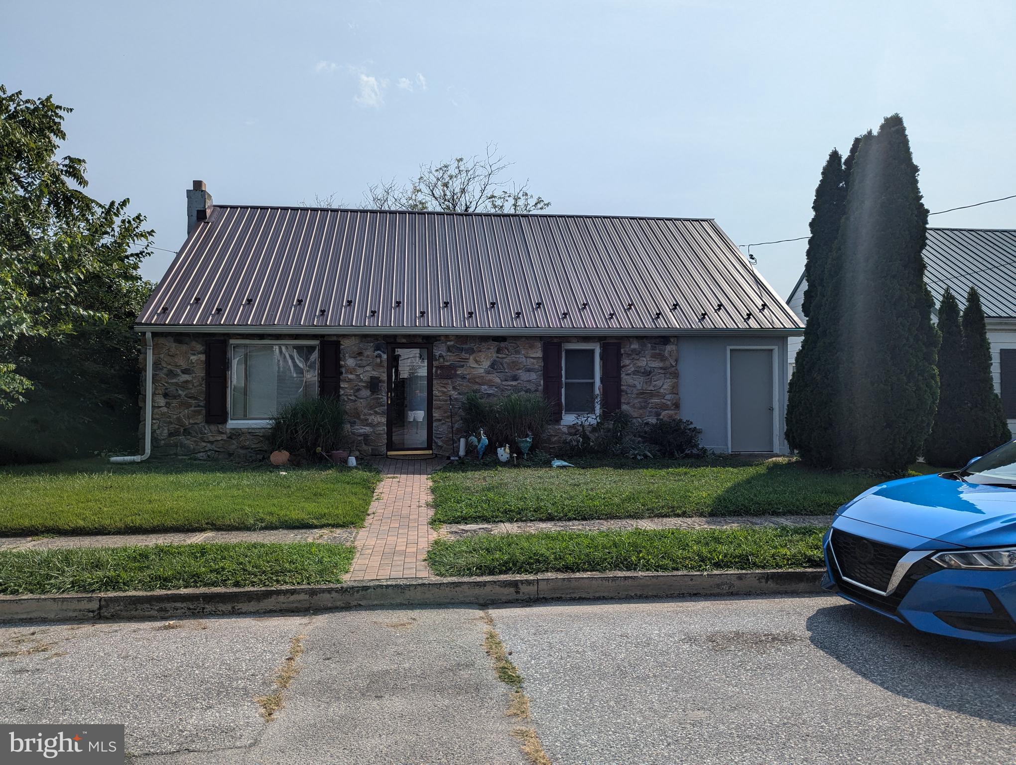 a front view of a house with a garden and pathway