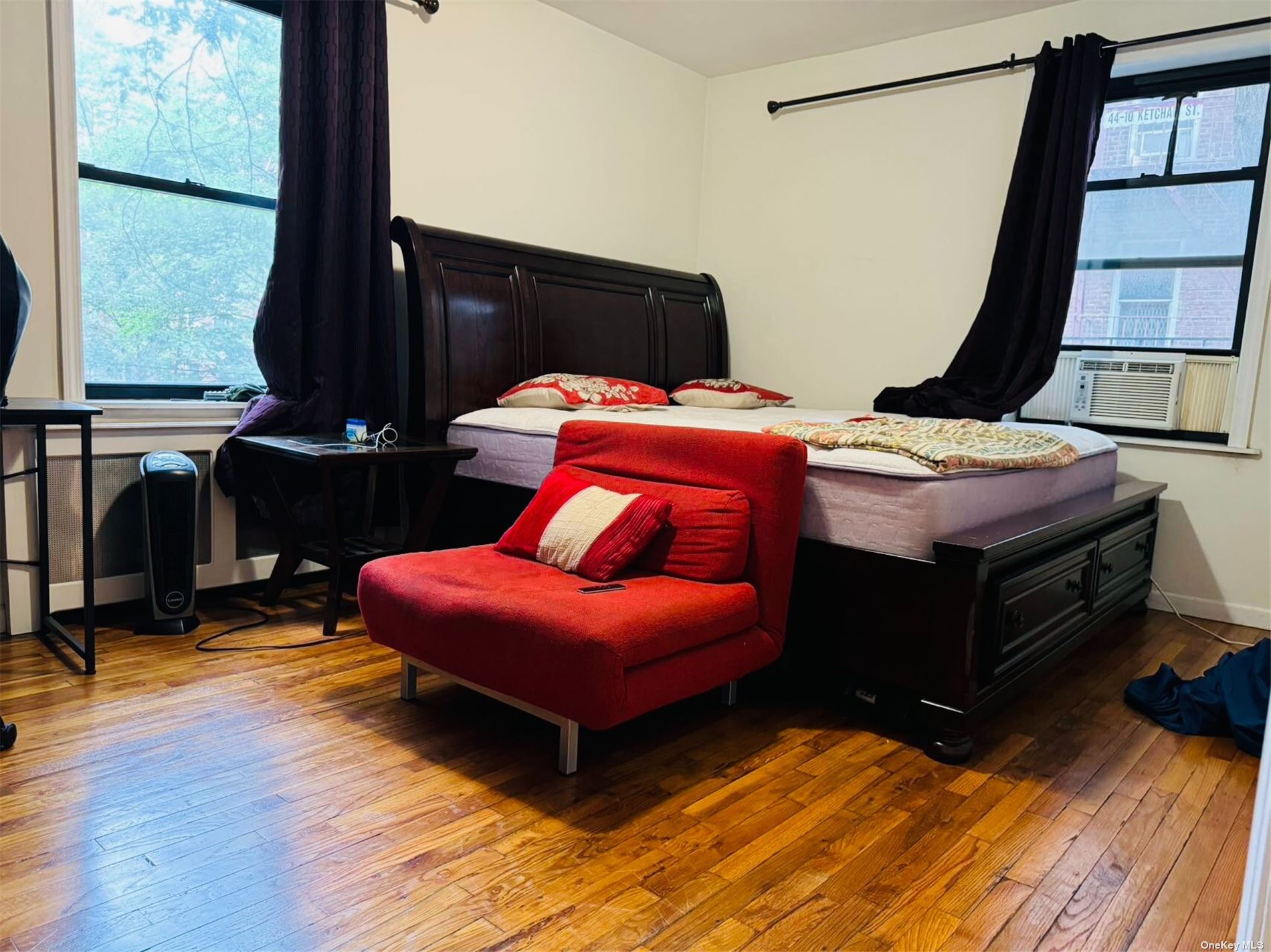 a bedroom with furniture and a window