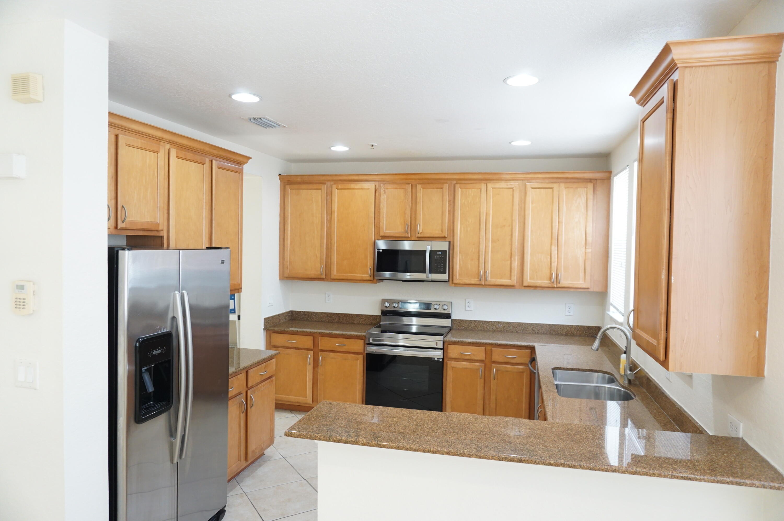 a kitchen with a refrigerator a sink and a window