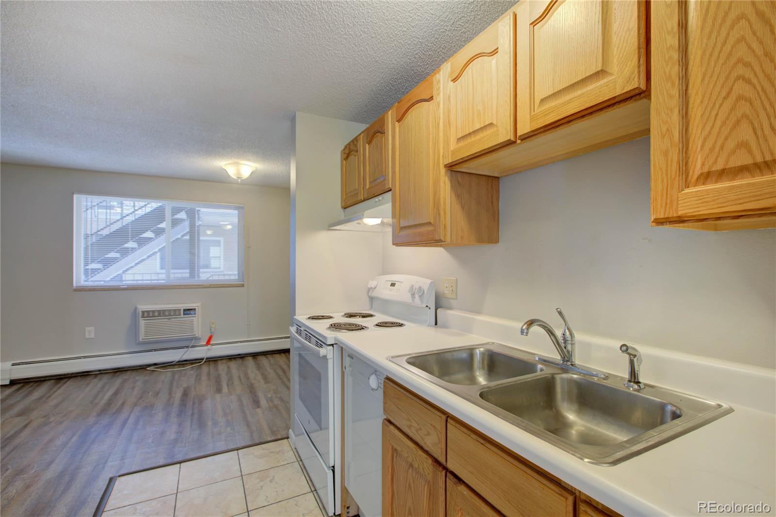 a kitchen with stainless steel appliances granite countertop a sink a stove and cabinets