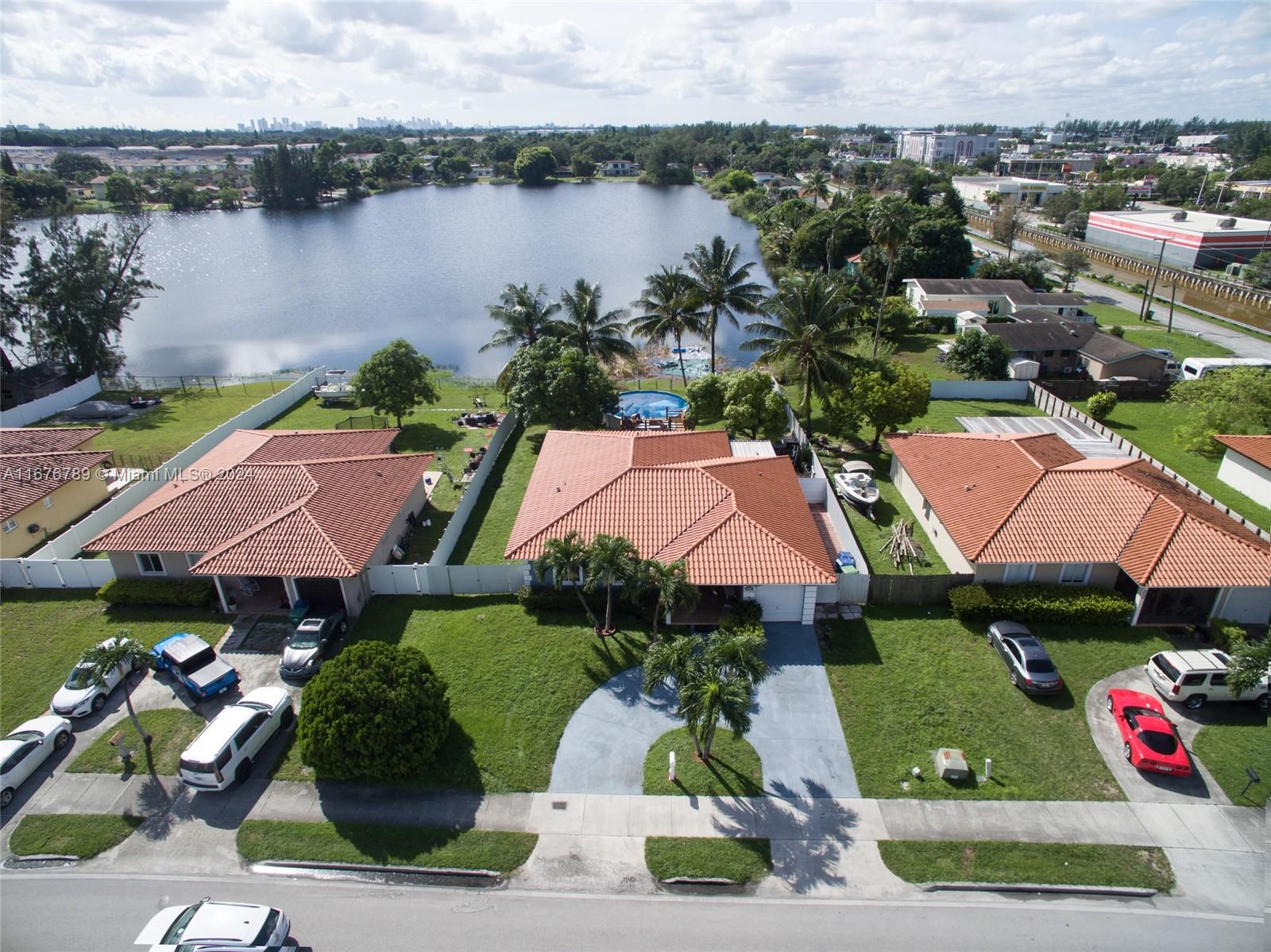 a view of houses with yard and lake view