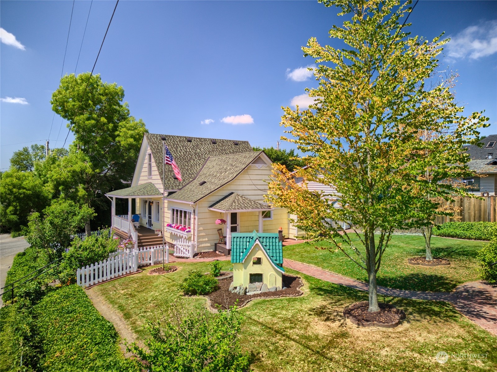 a view of a house with a backyard and a tree