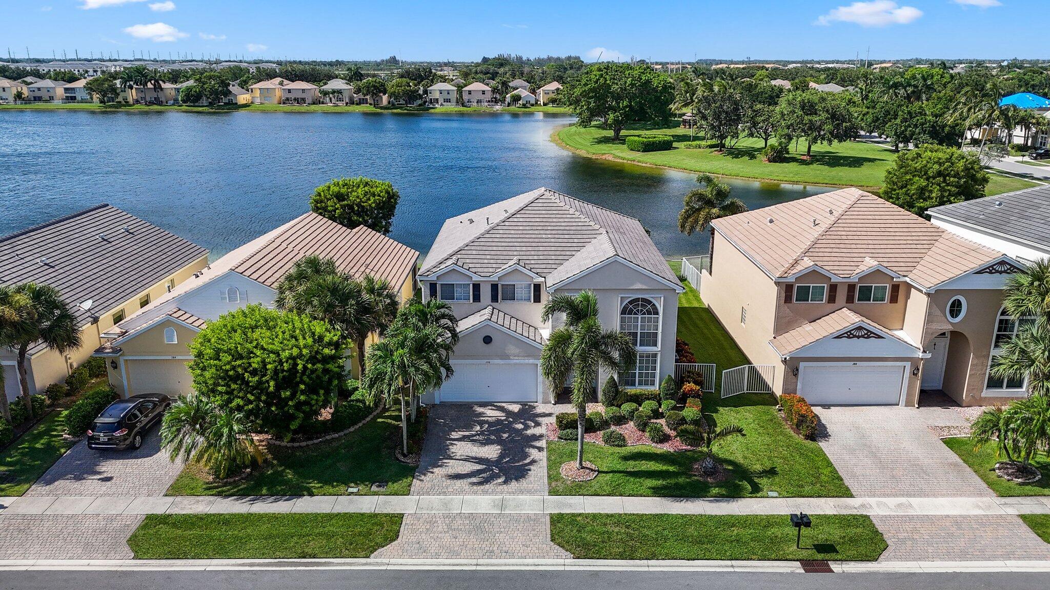 an aerial view of a house with garden space and lake view