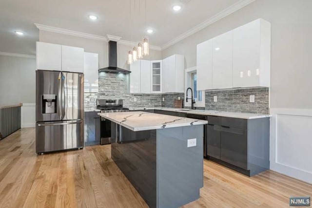 a kitchen with kitchen island granite countertop a sink appliances and cabinets