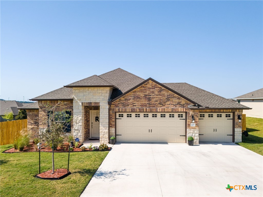 a front view of a house with a yard and garage