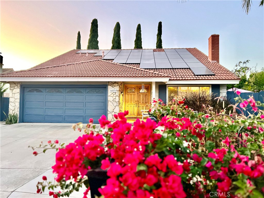 a front view of house and flowers