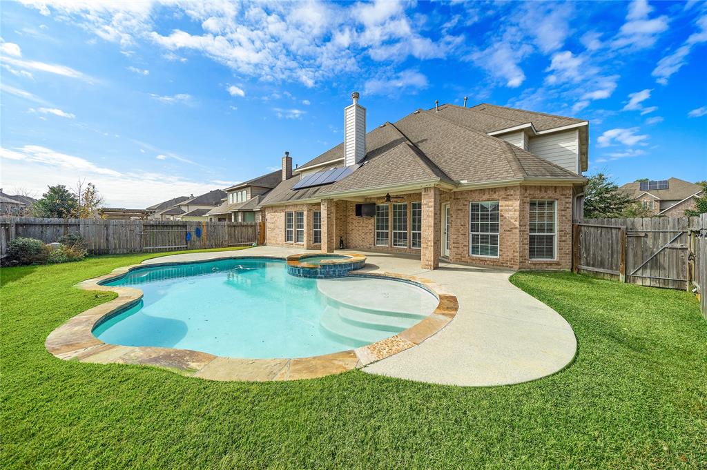 a view of a house with pool and yard