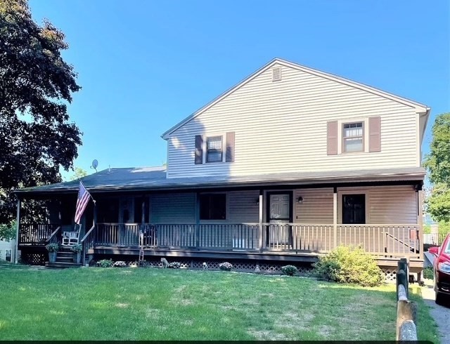 a view of a house with a yard and plants