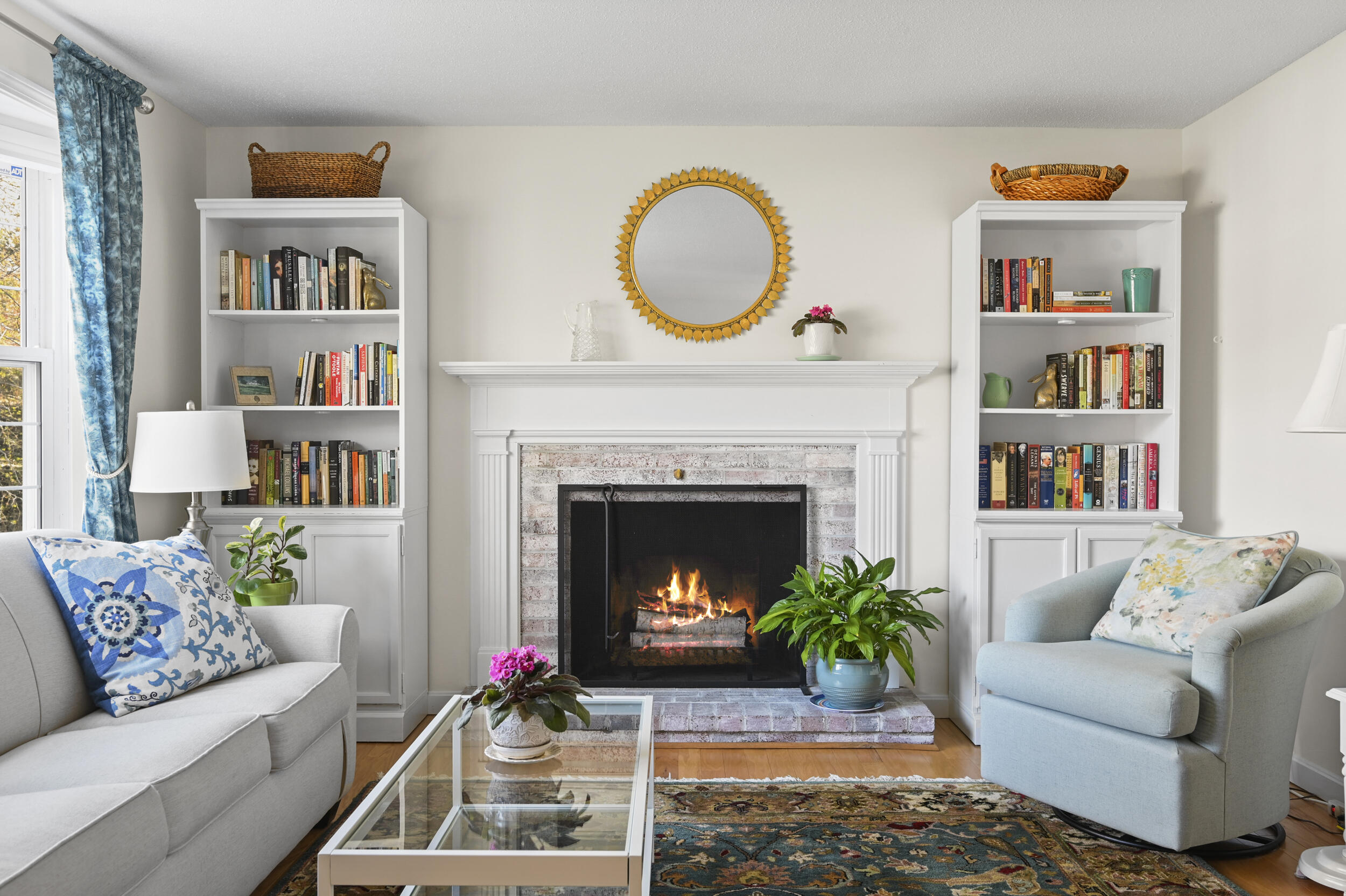 a living room with furniture and a fireplace