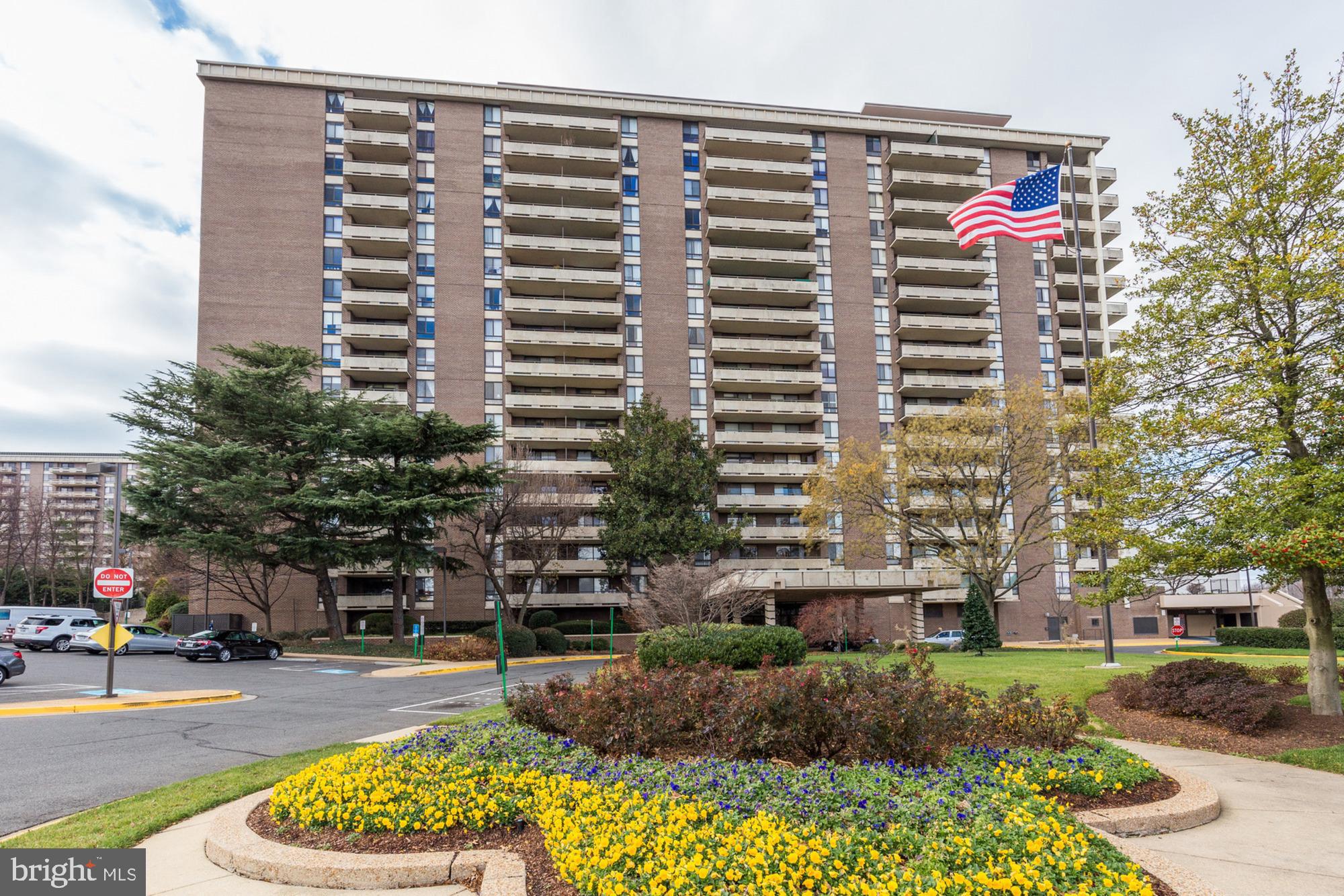 a front view of a multi story building with yard