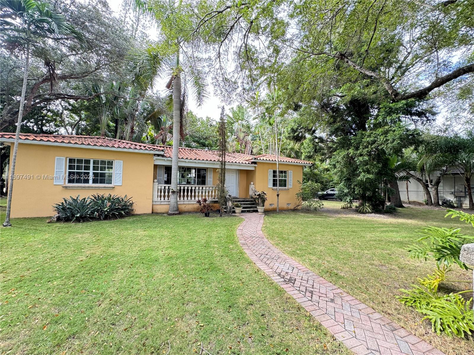 a view of a house with a yard and sitting area