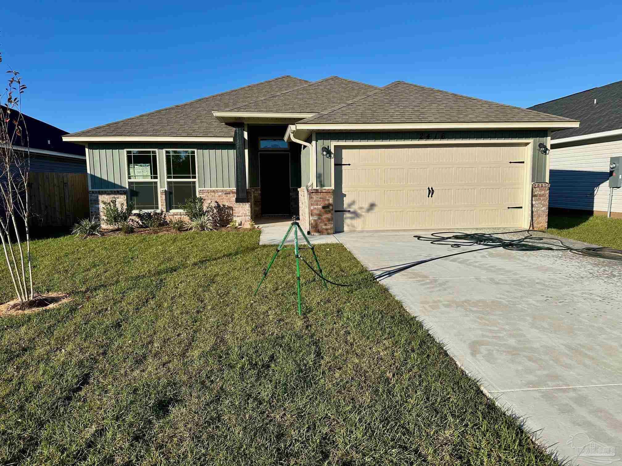 a front view of a house with yard outdoor seating and barbeque oven