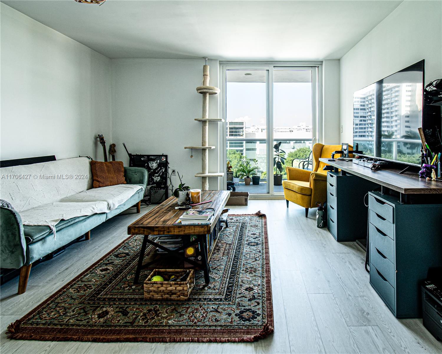 a living room with furniture hard wood floor and a rug