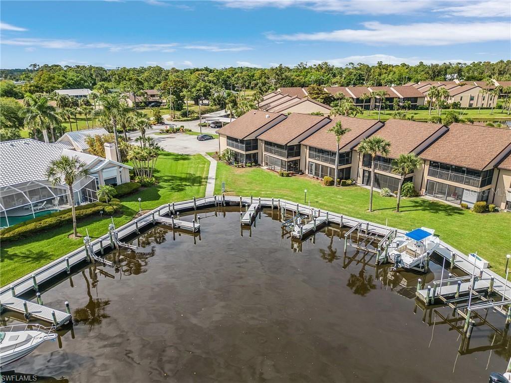 an aerial view of a house with a garden and lake view