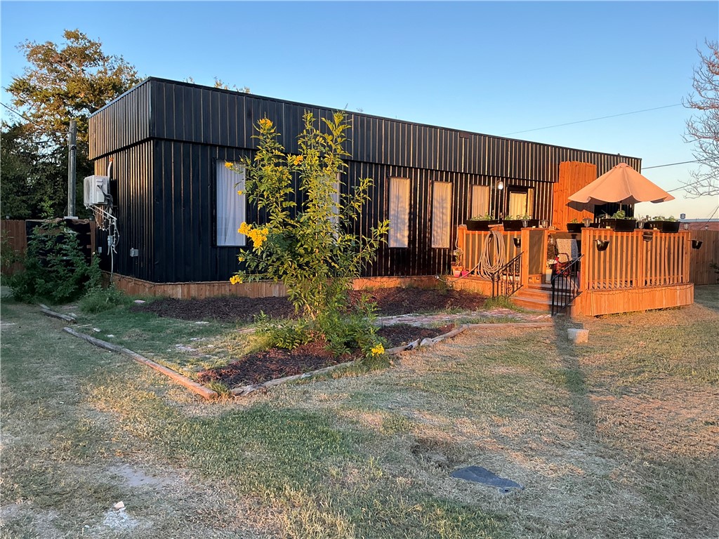 a view of a house with backyard and sitting area