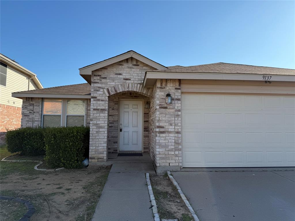 a front view of a house with garage