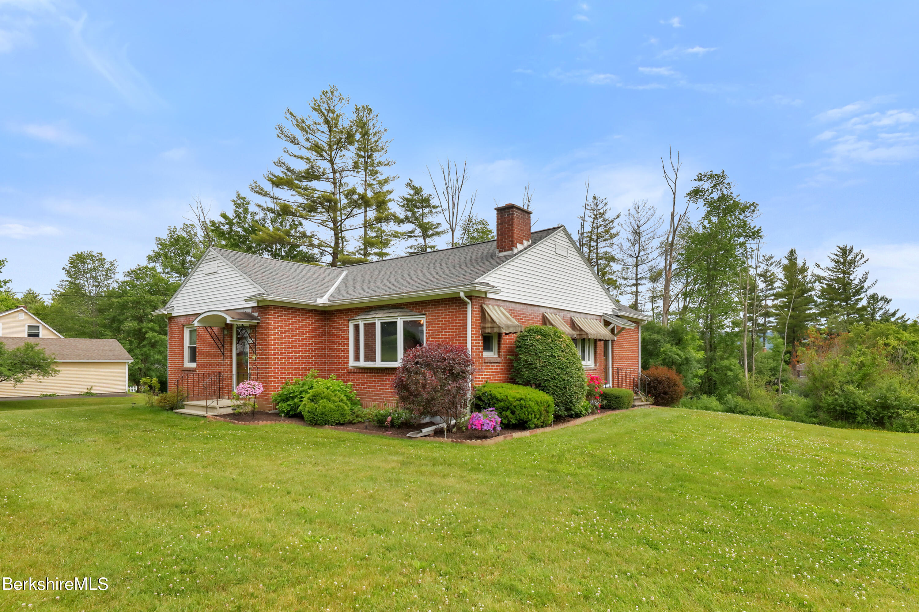 a front view of house with yard and green space