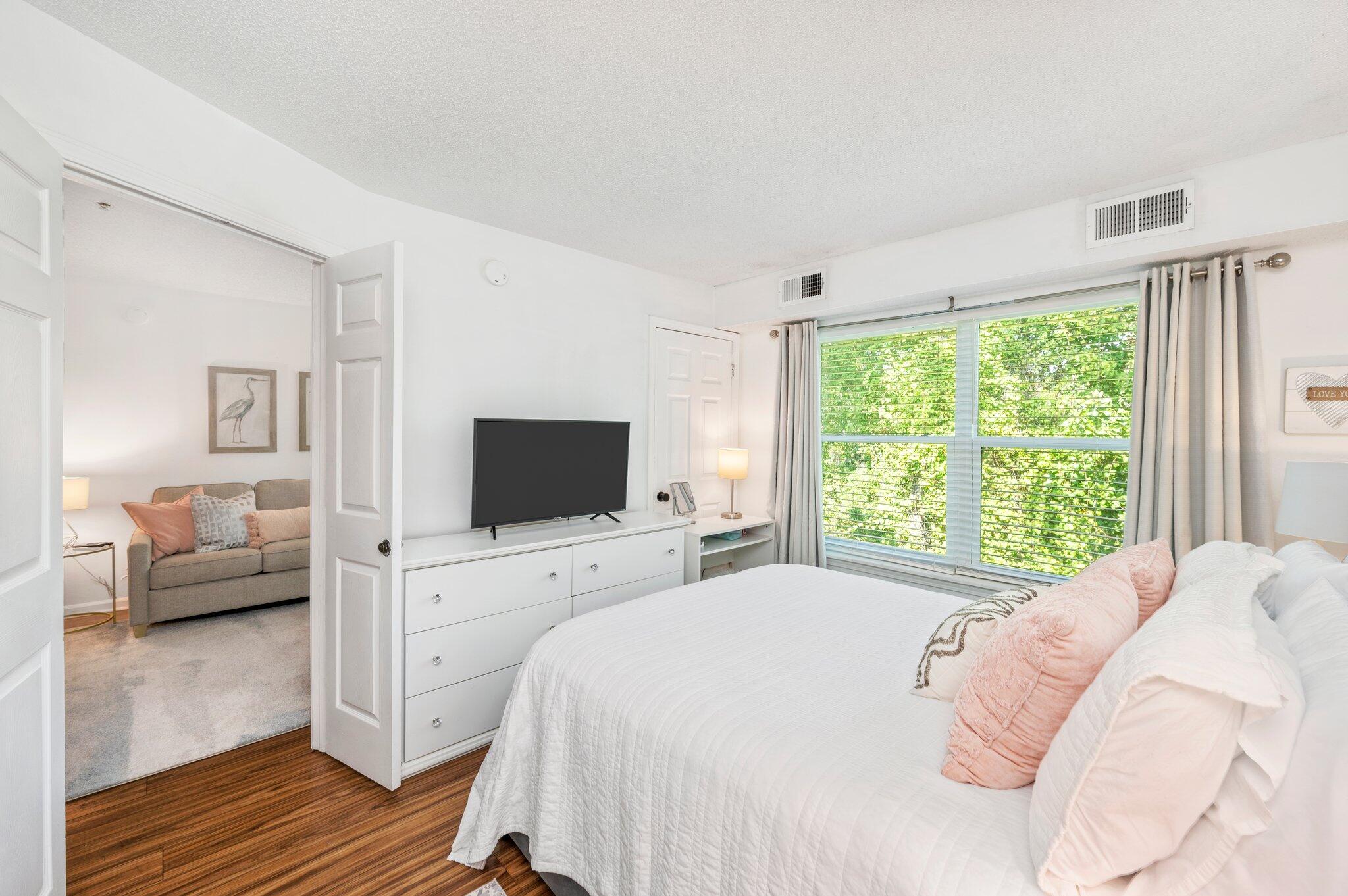 a bedroom with a bed and a flat screen tv