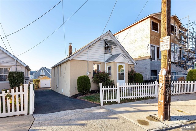 a front view of a house with iron fence