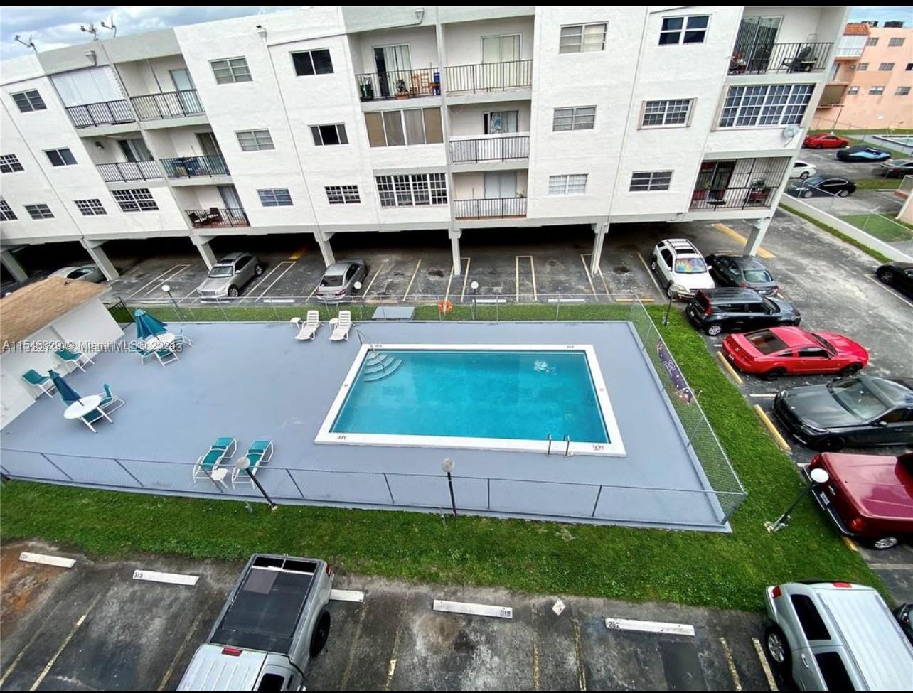 a view of a swimming pool with outdoor seating