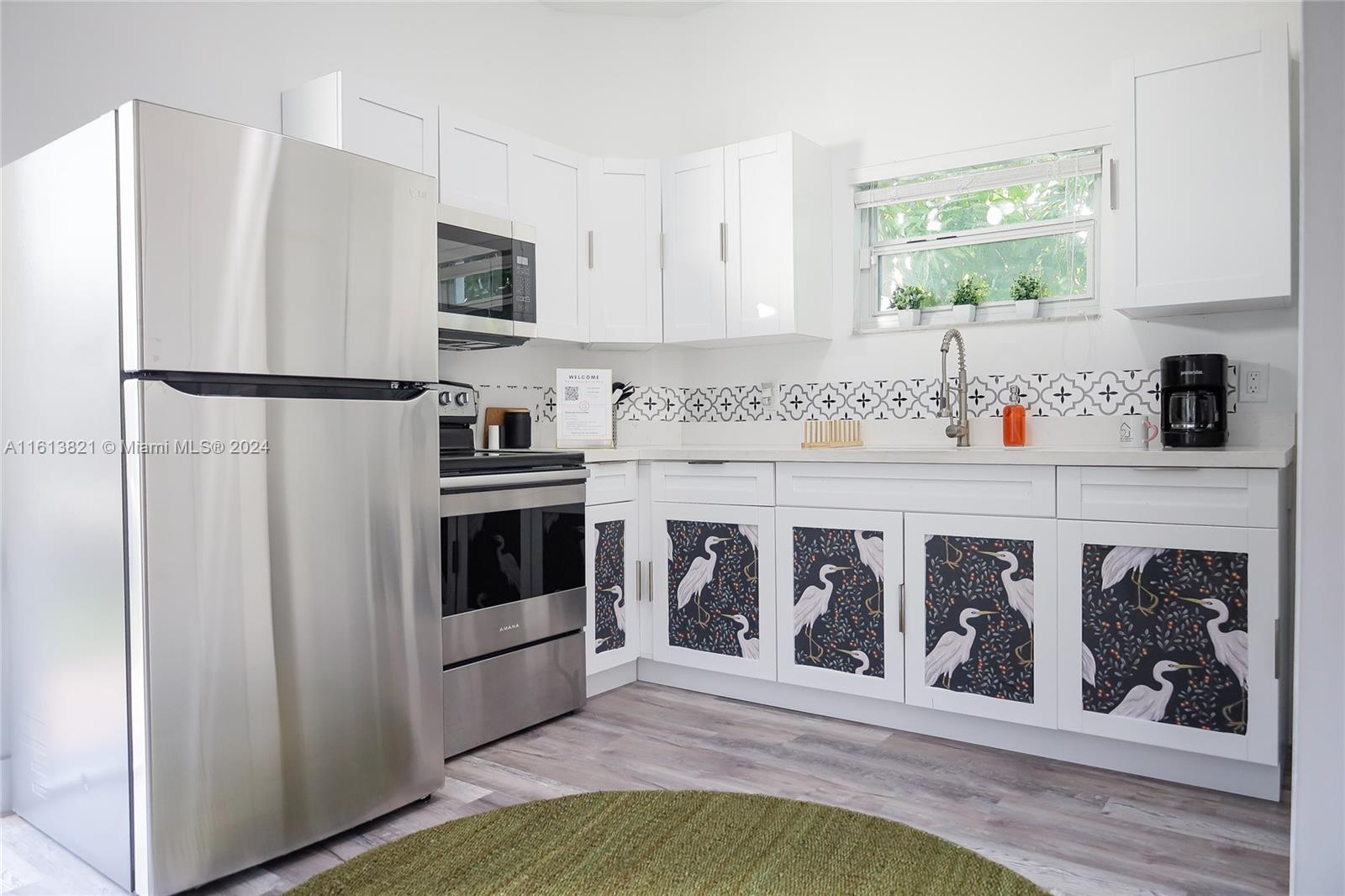 a kitchen with stainless steel appliances a refrigerator and a stove top oven