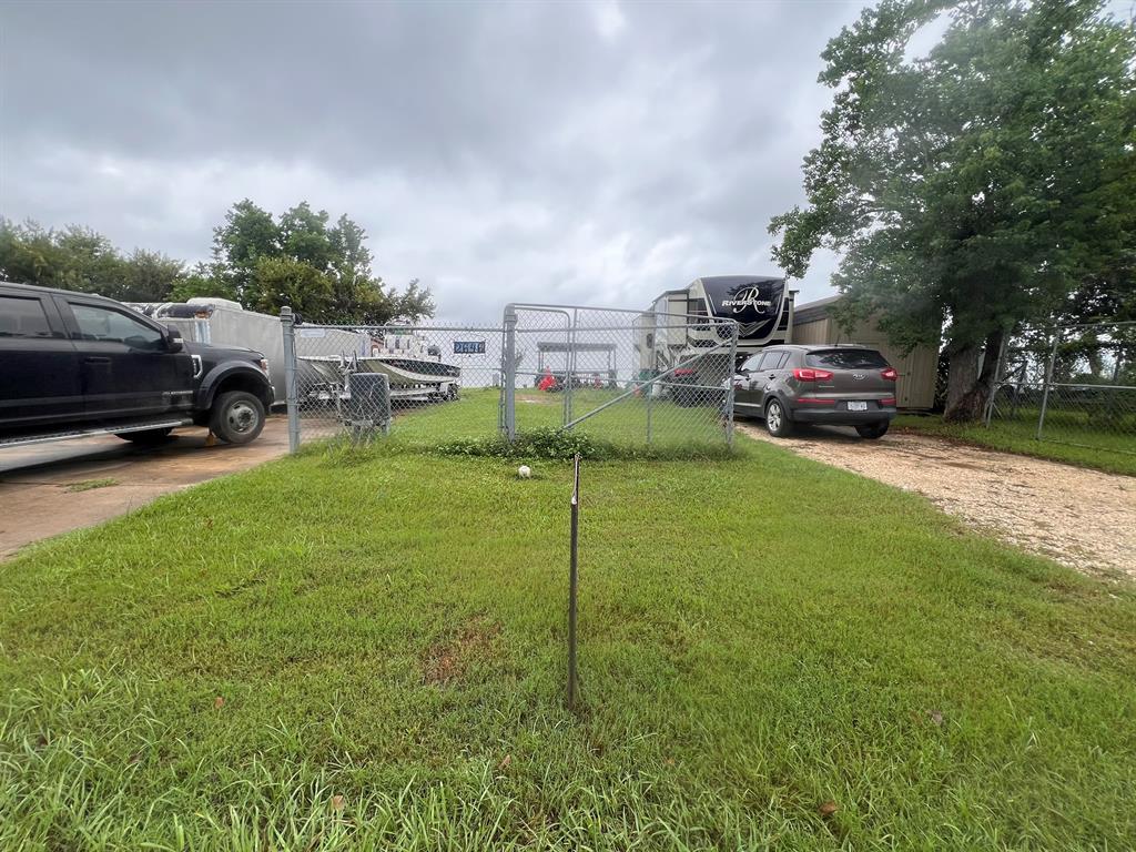 a view of a garden with cars parked