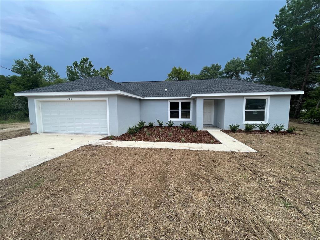 a view of a house with a yard and garage