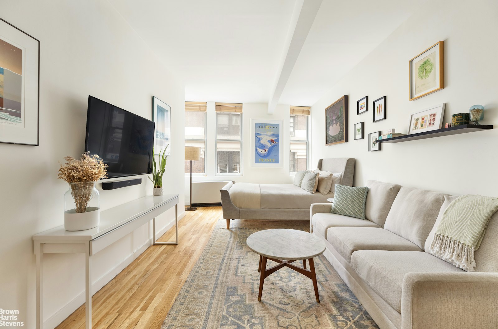 a living room with furniture and a flat screen tv