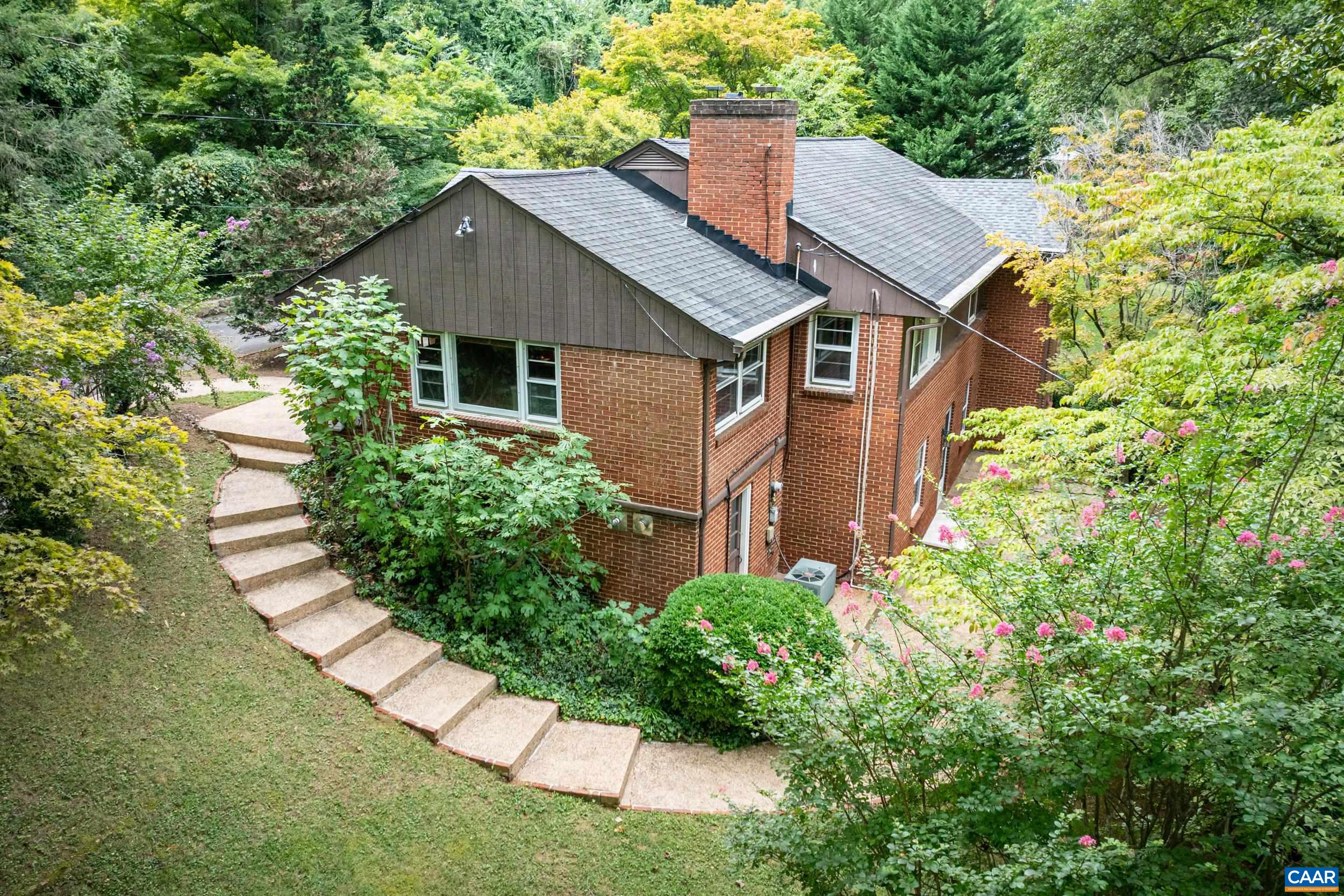 a aerial view of a house next to a yard