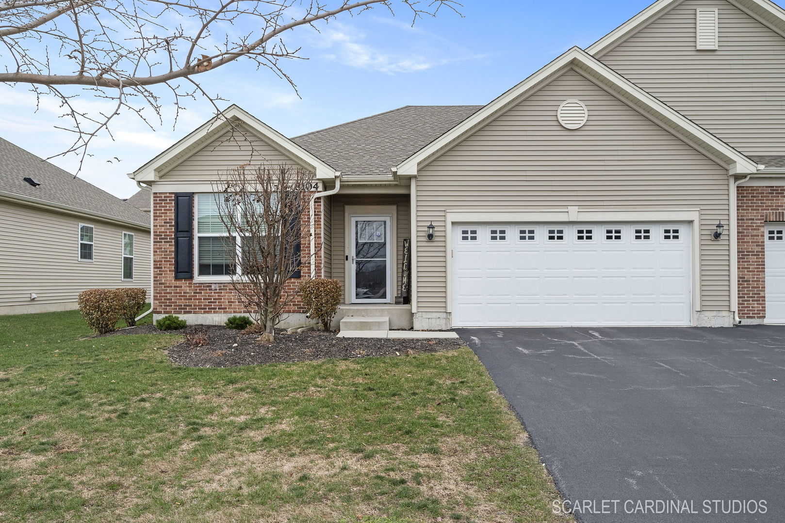 a view of a house with yard and a garage