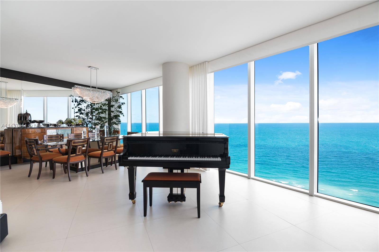 a living room with furniture a table and a large window