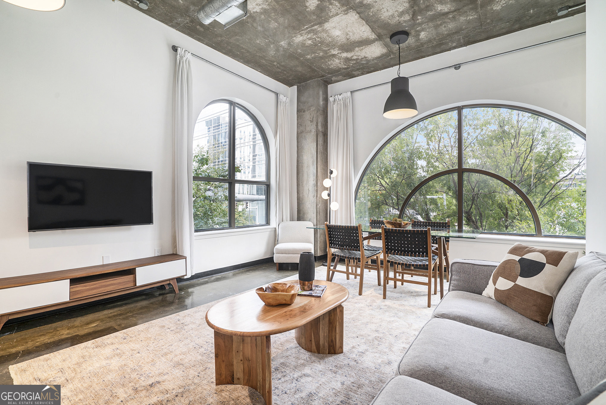 a living room with furniture fireplace and flat screen tv