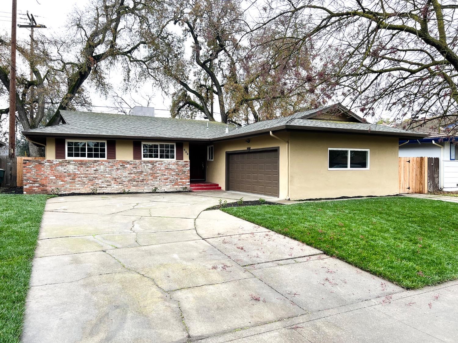 a front view of house with yard and green space