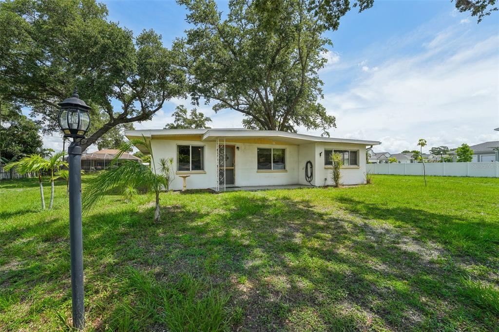 a view of a house with a backyard