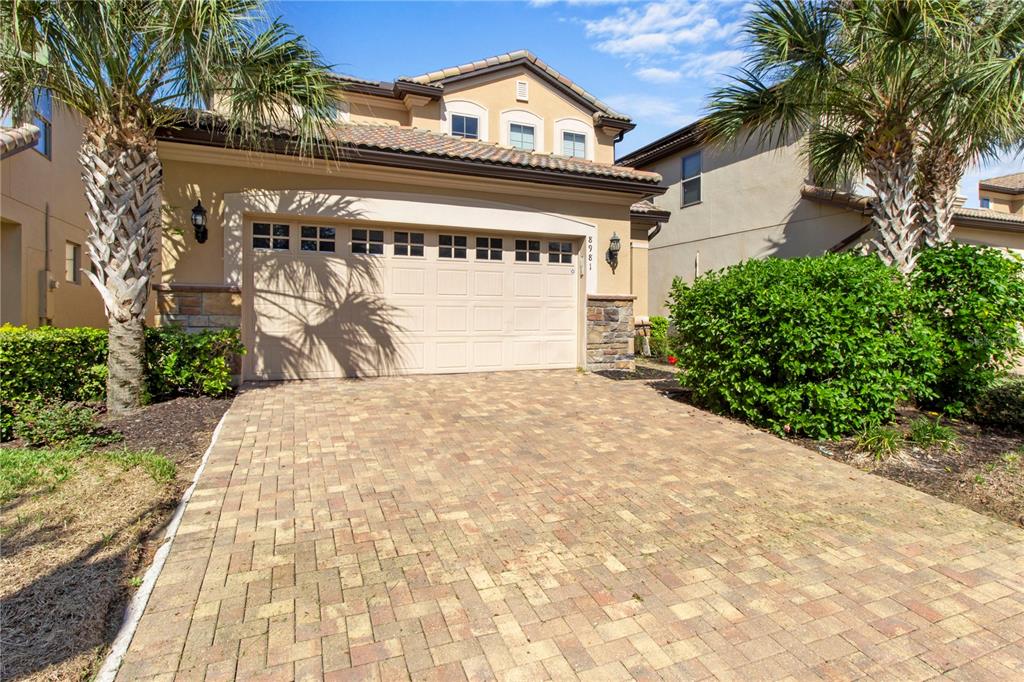 a view of a house with a large tree